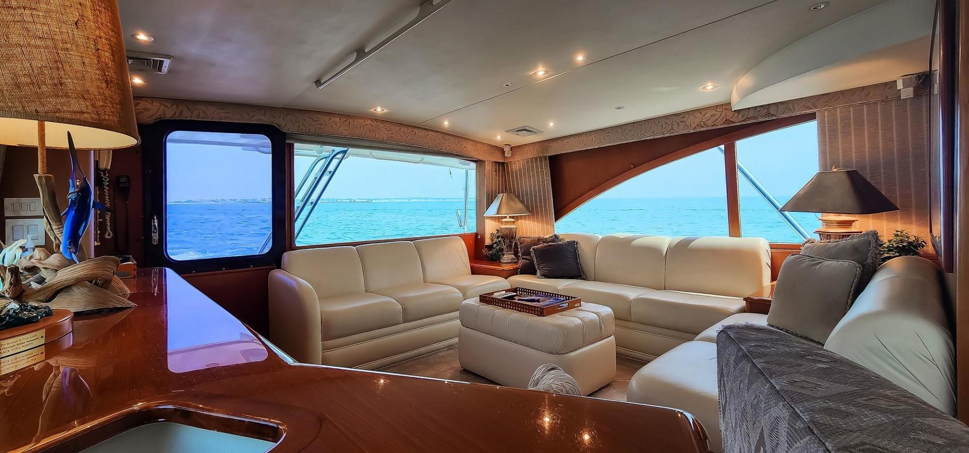 a living room with a large window aboard My Time Yacht for Sale