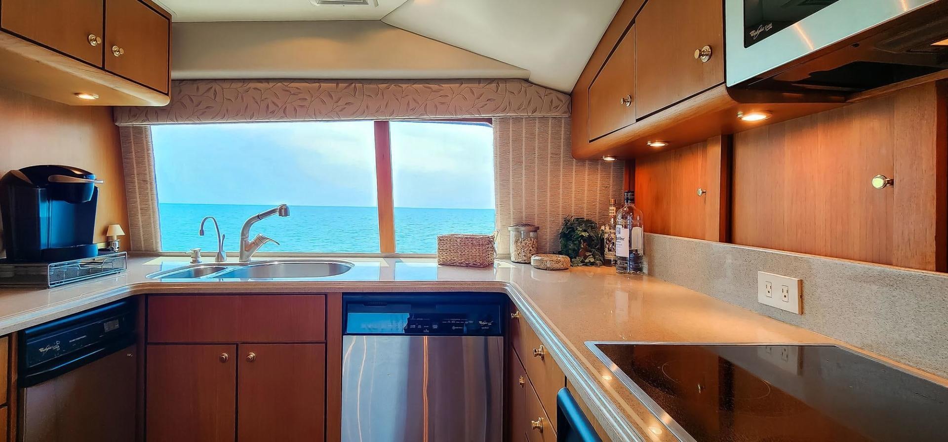 a kitchen with a sink and cabinets aboard My Time Yacht for Sale
