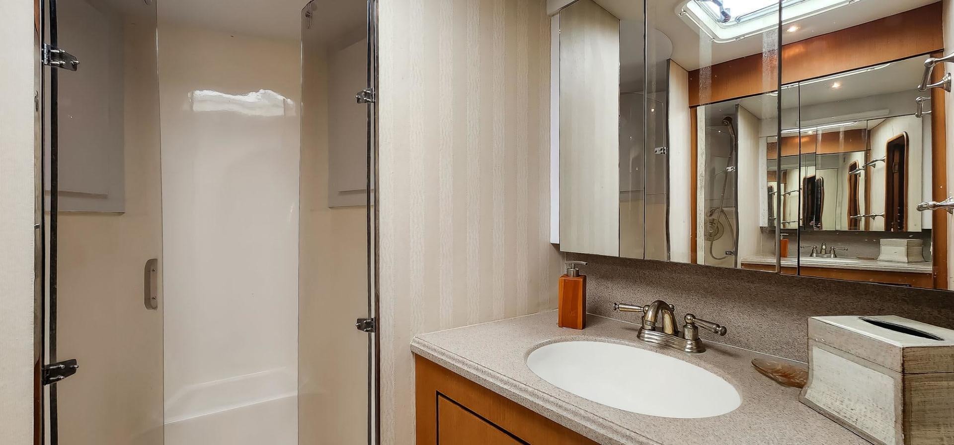 a bathroom with a sink and a mirror aboard My Time Yacht for Sale