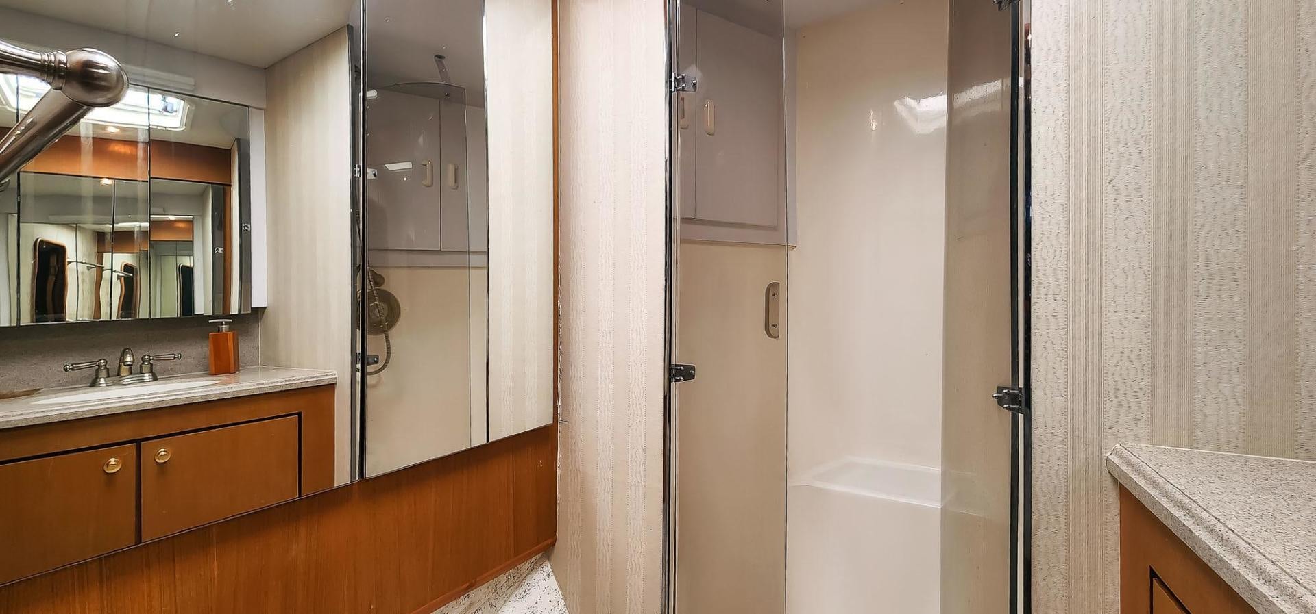 a bathroom with a shower unit and sink aboard My Time Yacht for Sale