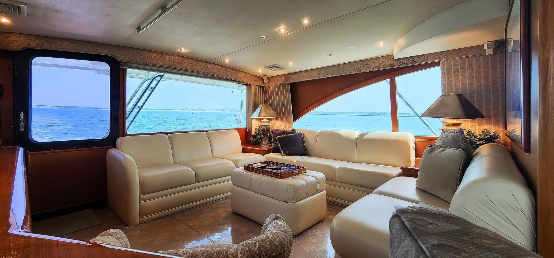 a living room with a large window aboard My Time Yacht for Sale