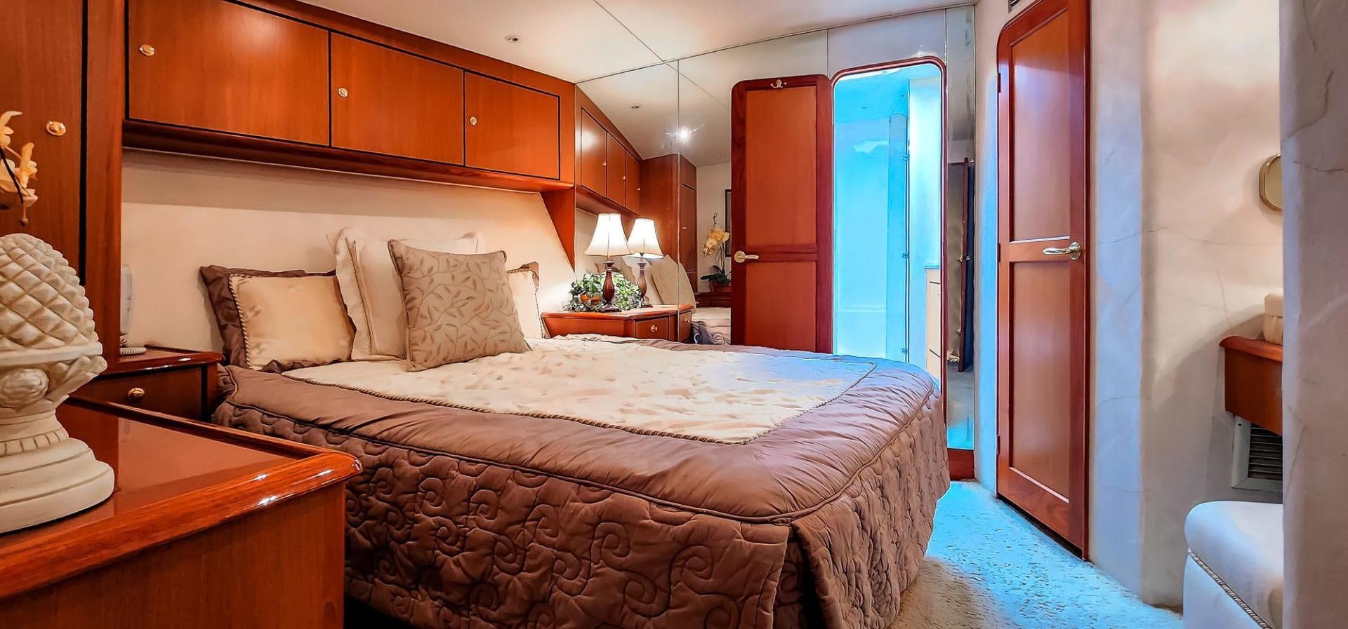 a large bed in a hotel room aboard My Time Yacht for Sale