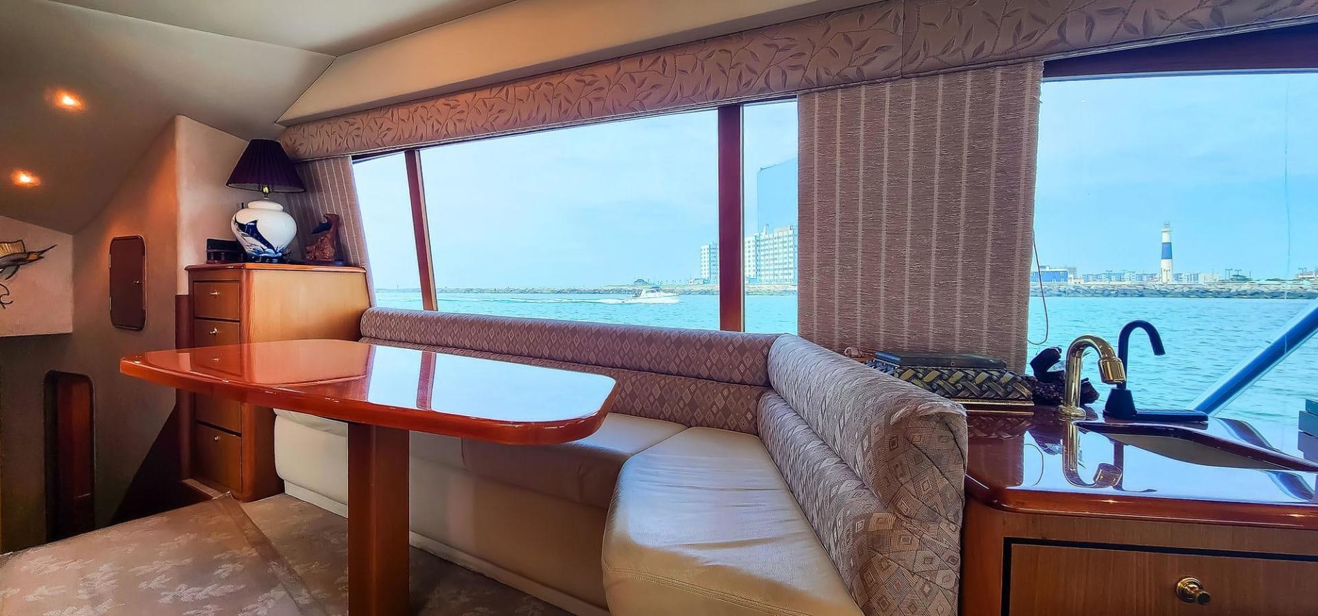 a living room with a large window aboard My Time Yacht for Sale