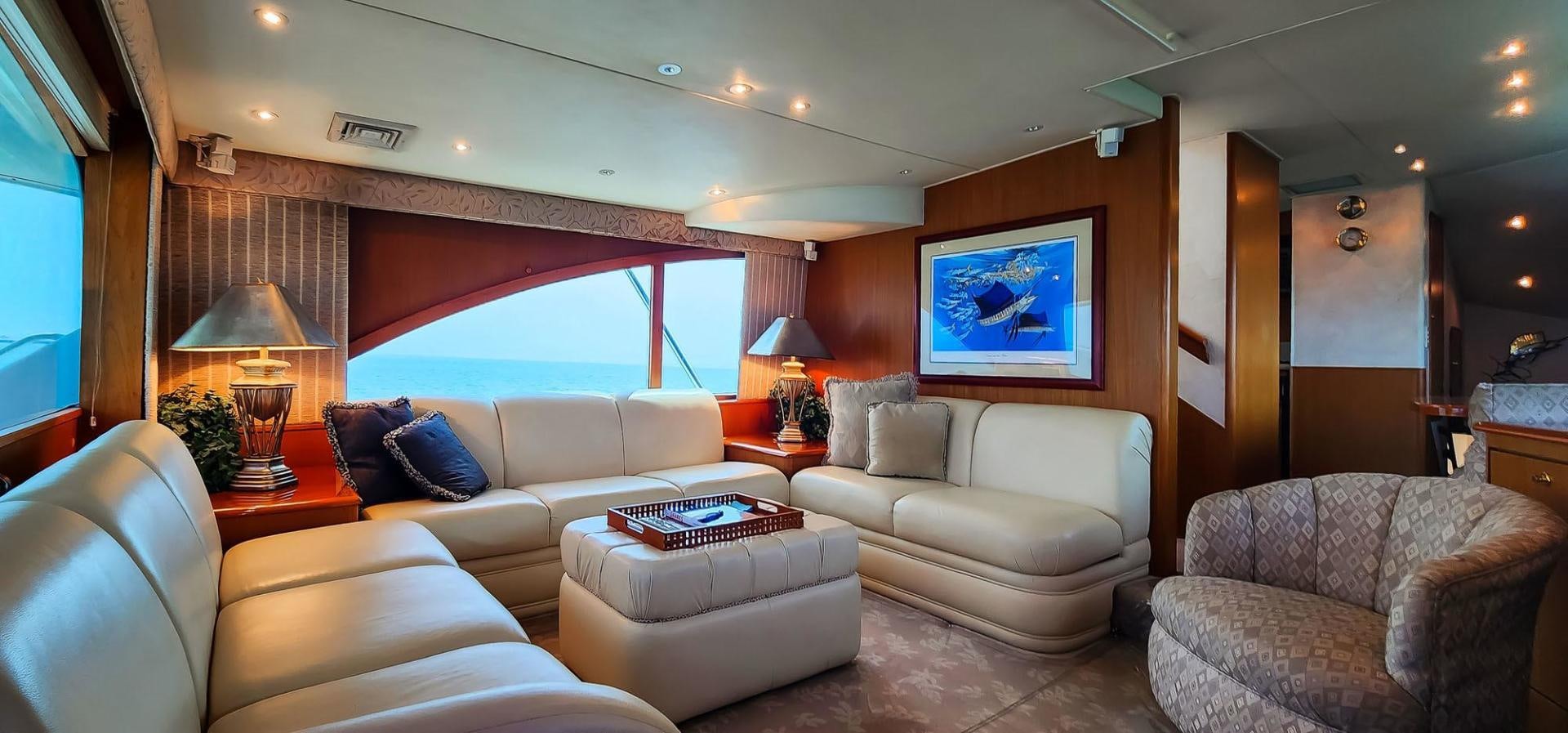 a living room with a large window aboard My Time Yacht for Sale