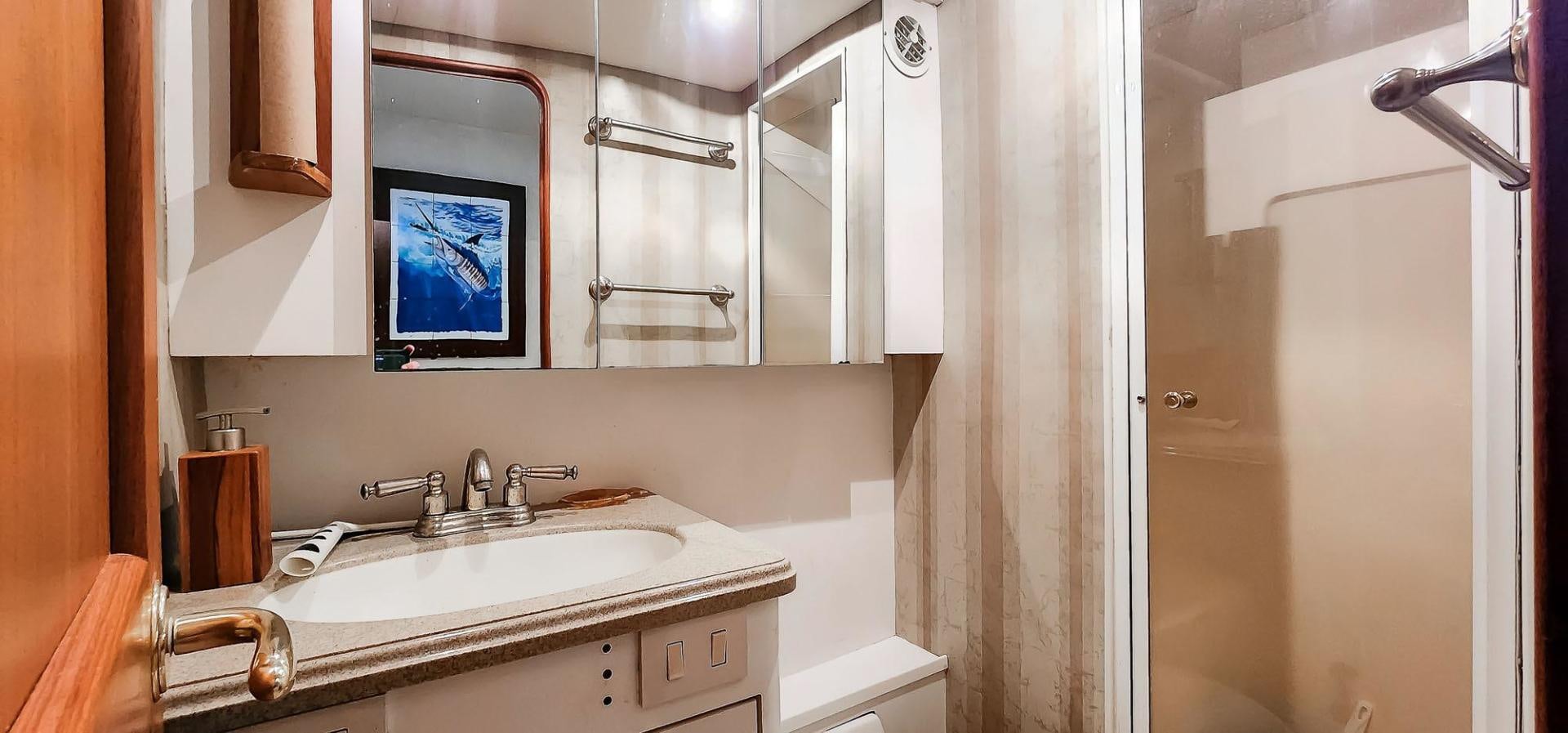 a bathroom with a sink and a mirror aboard My Time Yacht for Sale