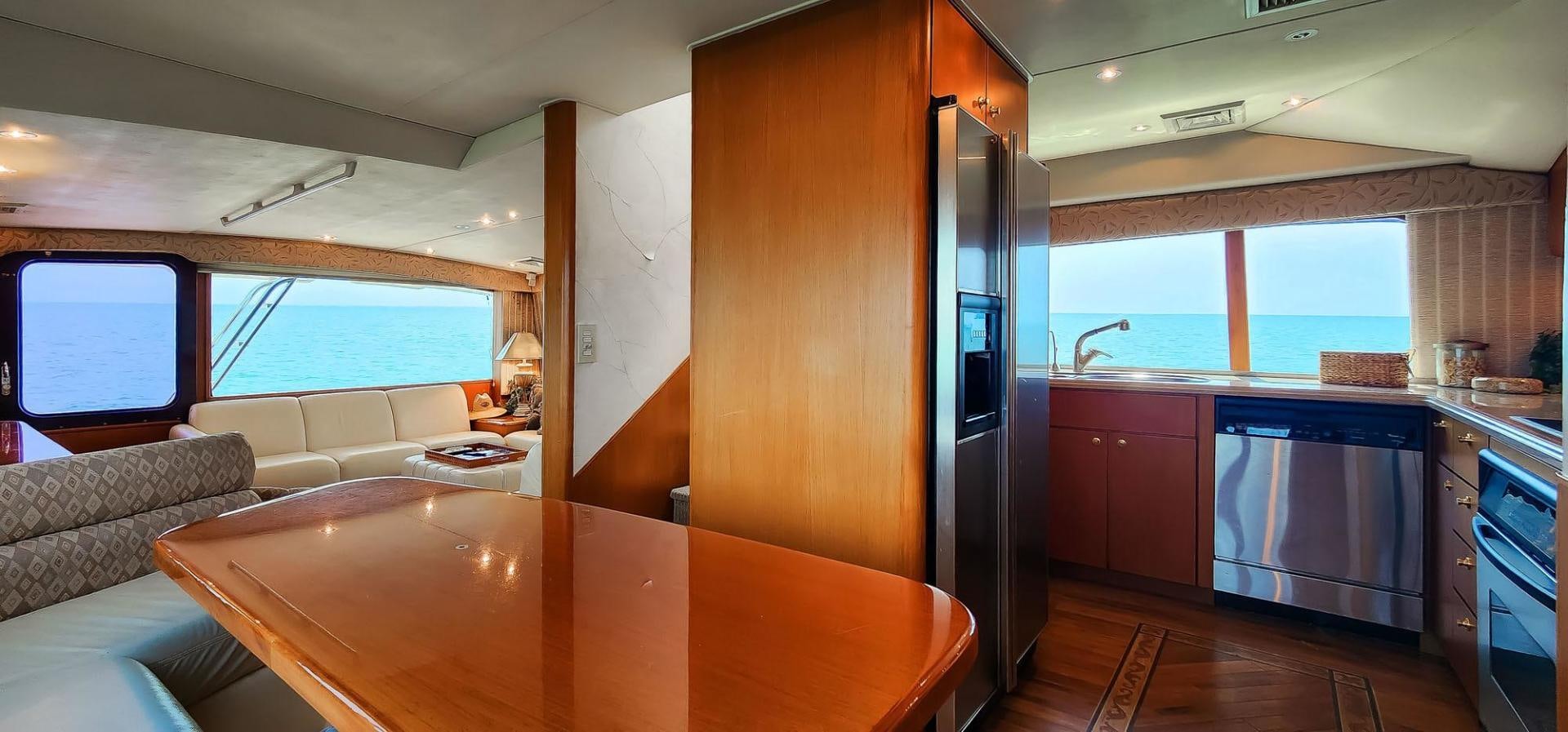 a kitchen with a table and a couch aboard My Time Yacht for Sale