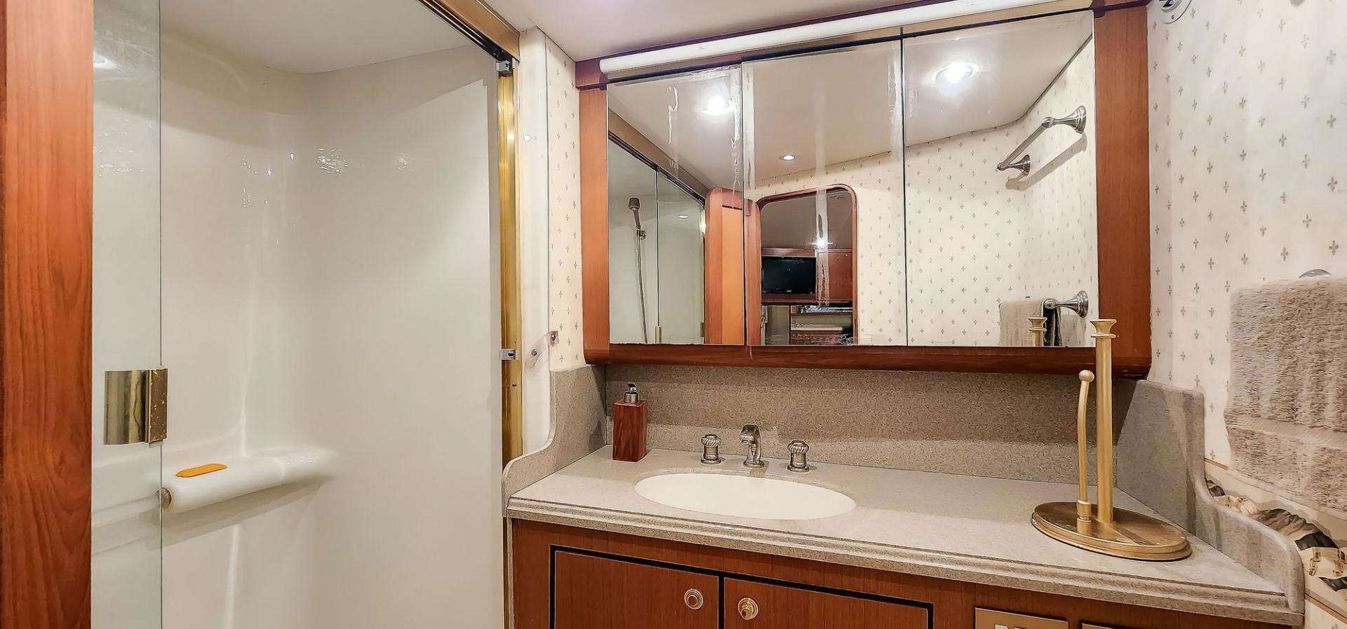 a bathroom with a large mirror aboard My Time Yacht for Sale