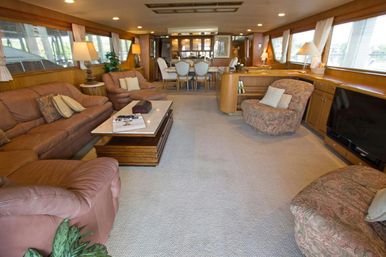 a living room with a piano and a table aboard GOLDEN RULE Yacht for Sale