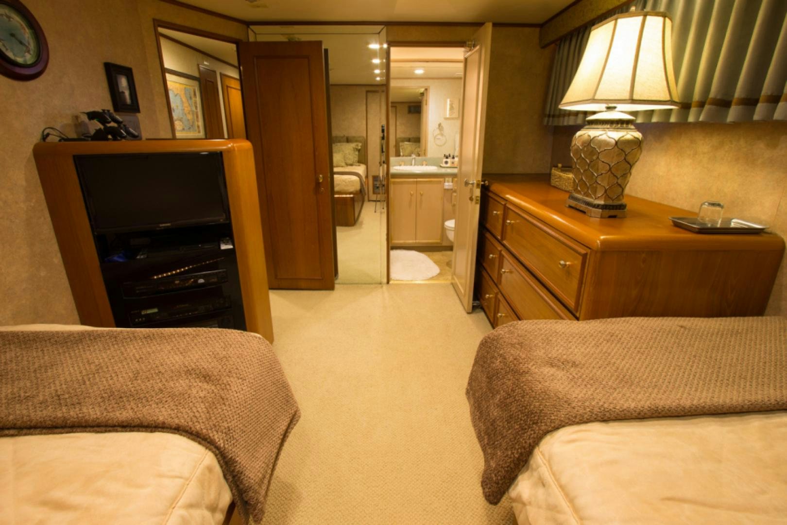 a bedroom with a bed and a television aboard GOLDEN RULE Yacht for Sale