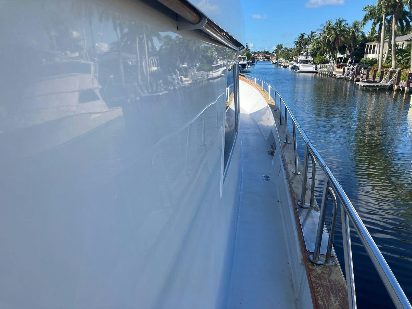 a boat with a reflection of a city on the water aboard GOLDEN RULE Yacht for Sale
