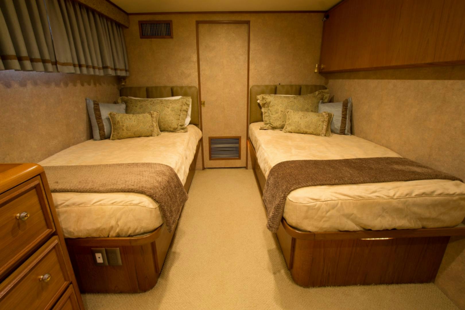 a room with beds and a door aboard GOLDEN RULE Yacht for Sale