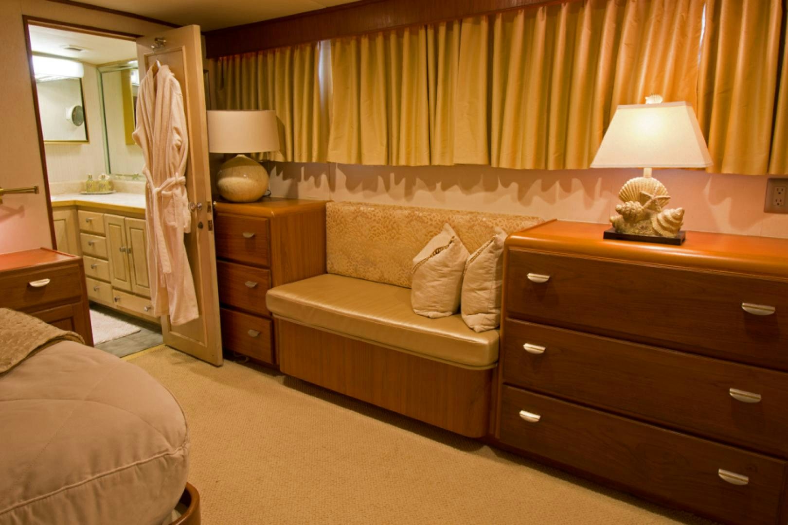 a bedroom with a bed and a dresser aboard GOLDEN RULE Yacht for Sale