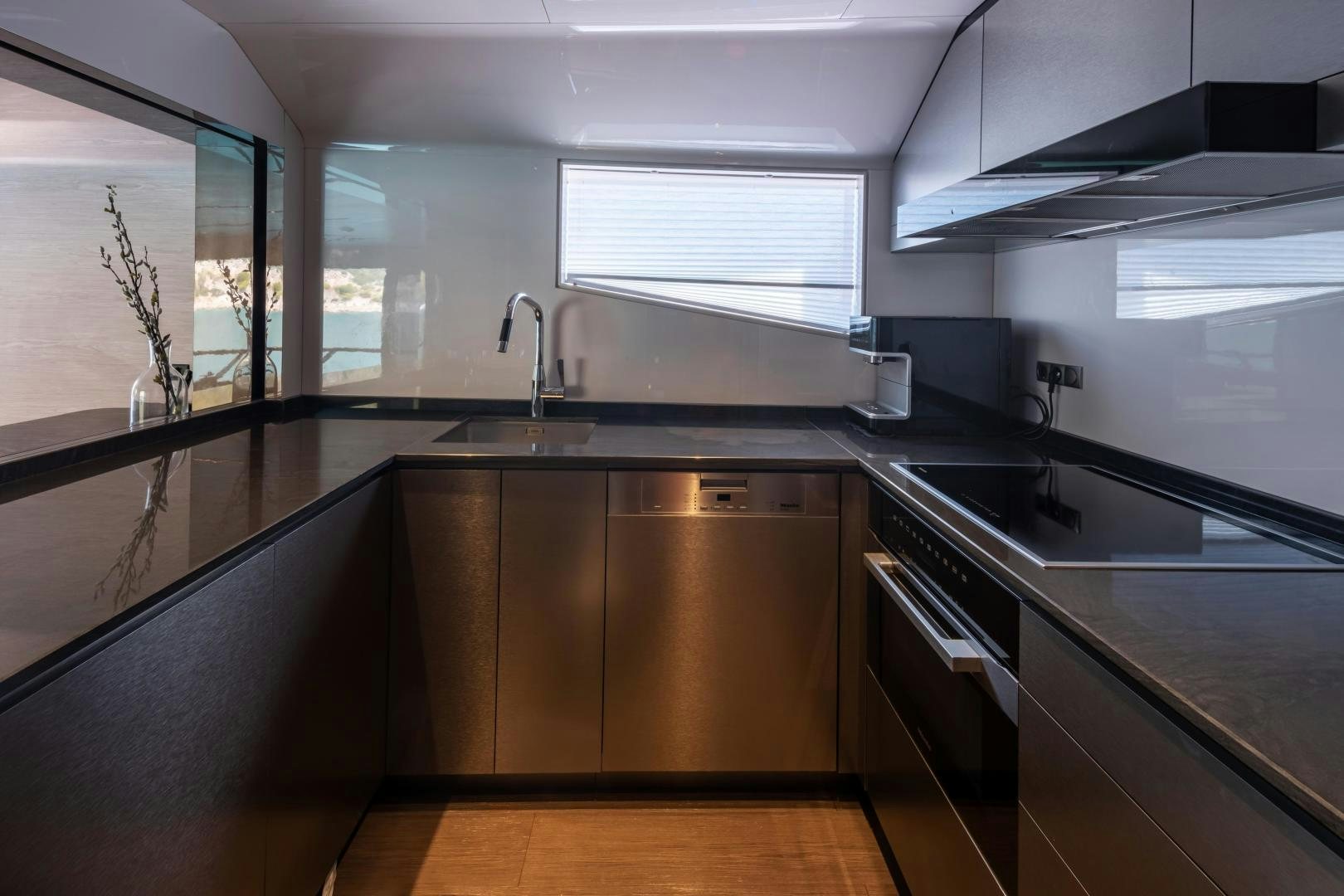 a kitchen with black counters aboard EDGE   NB 201 Yacht for Sale