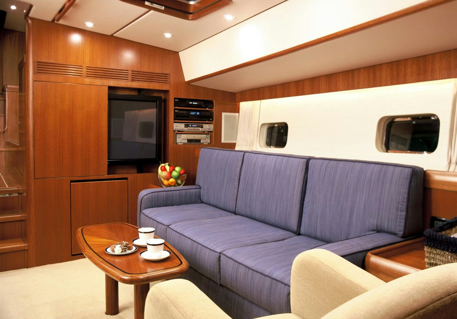 a living room with a couch and a table aboard ADJUTOR Yacht for Sale