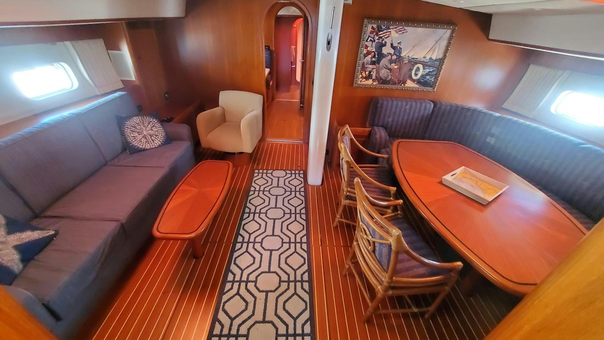a living room with a couch and a table aboard ADJUTOR Yacht for Sale