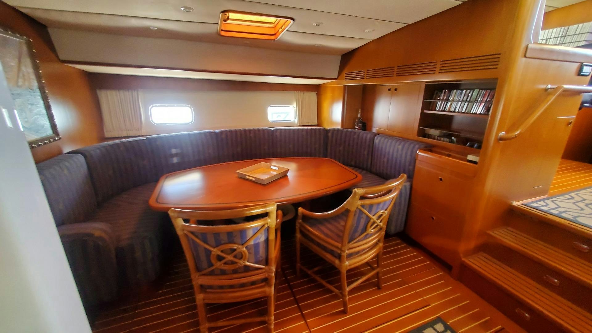 a room with a table and chairs aboard ADJUTOR Yacht for Sale
