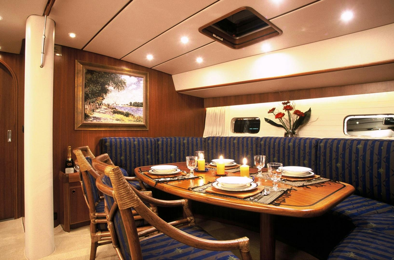a dining table with plates and glasses aboard ADJUTOR Yacht for Sale