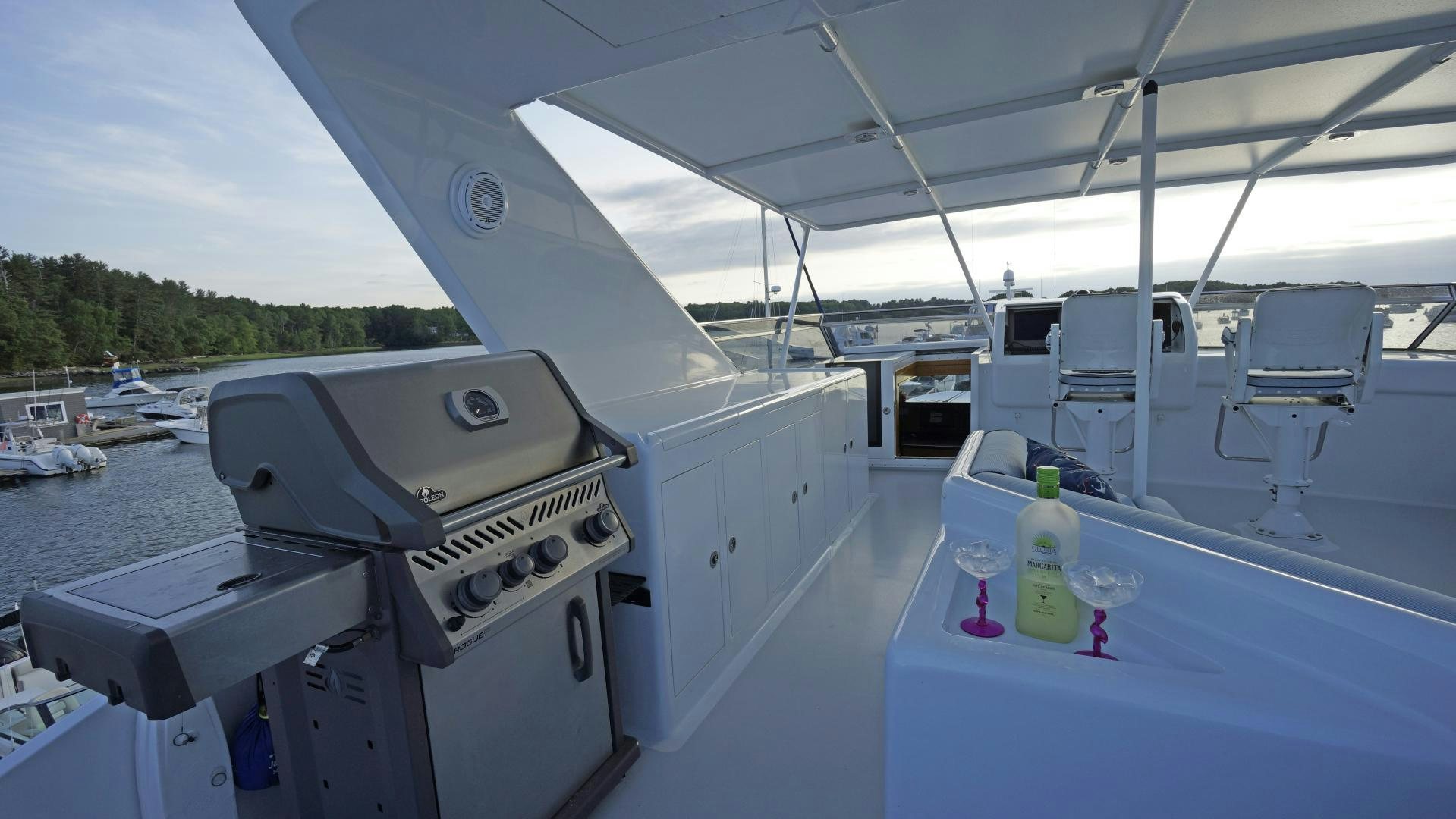 a boat with a bottle on the deck aboard LAID BACK Yacht for Sale