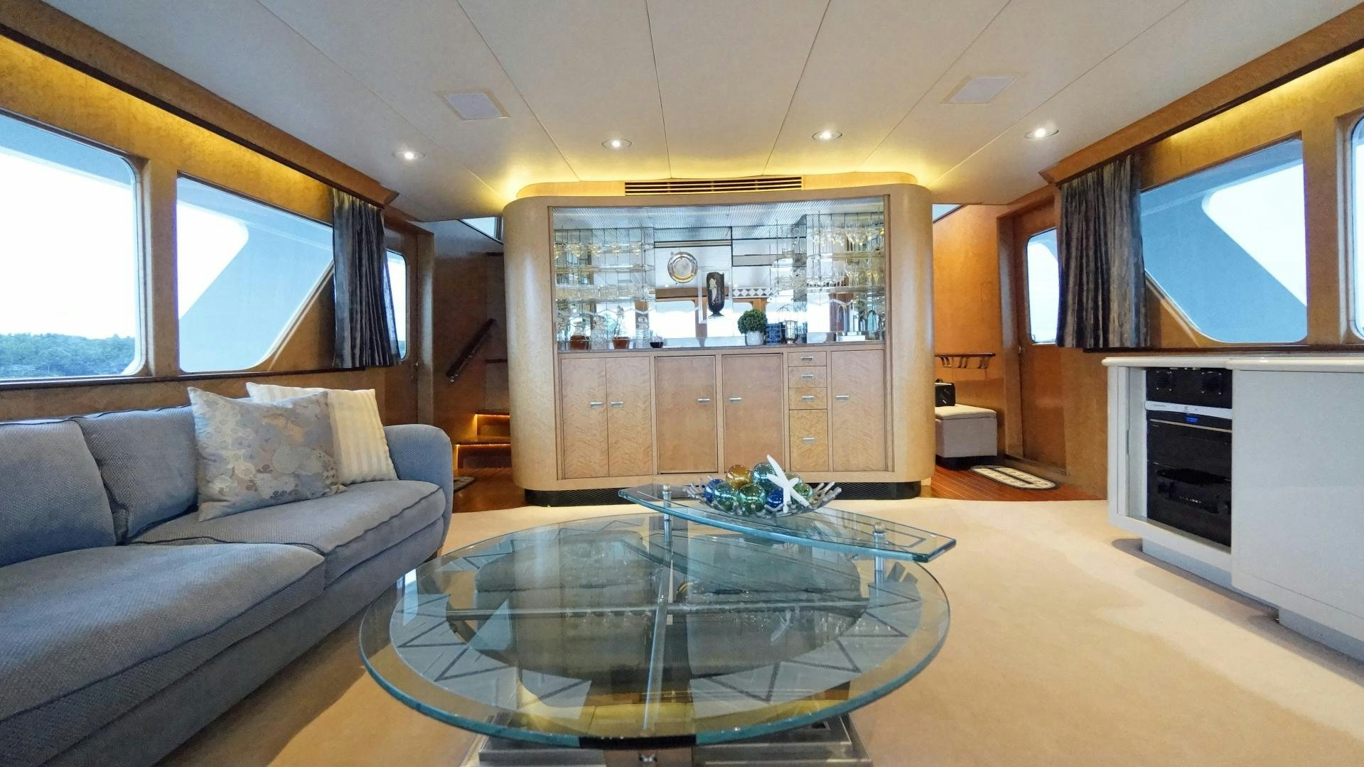 a living room with a large glass table aboard LAID BACK Yacht for Sale