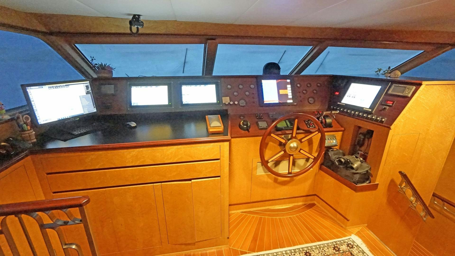a room with a wood paneled wall and a large round wheel aboard LAID BACK Yacht for Sale