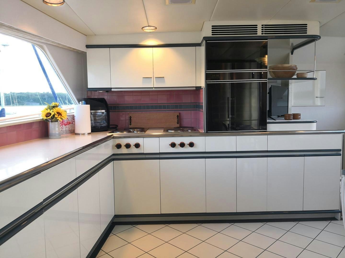 a kitchen with white cabinets aboard LAID BACK Yacht for Sale