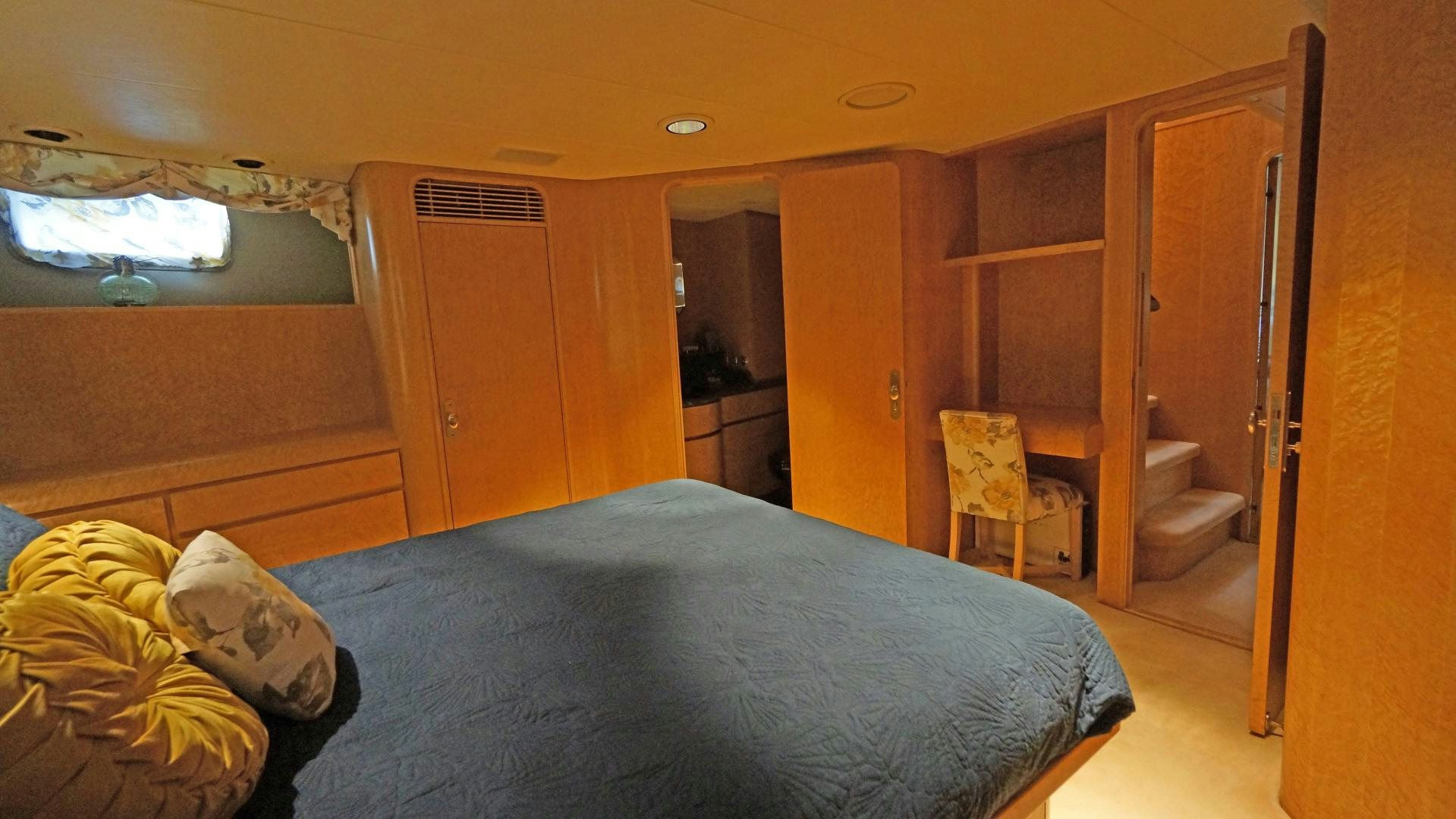 a bedroom with a bed and a closet aboard LAID BACK Yacht for Sale