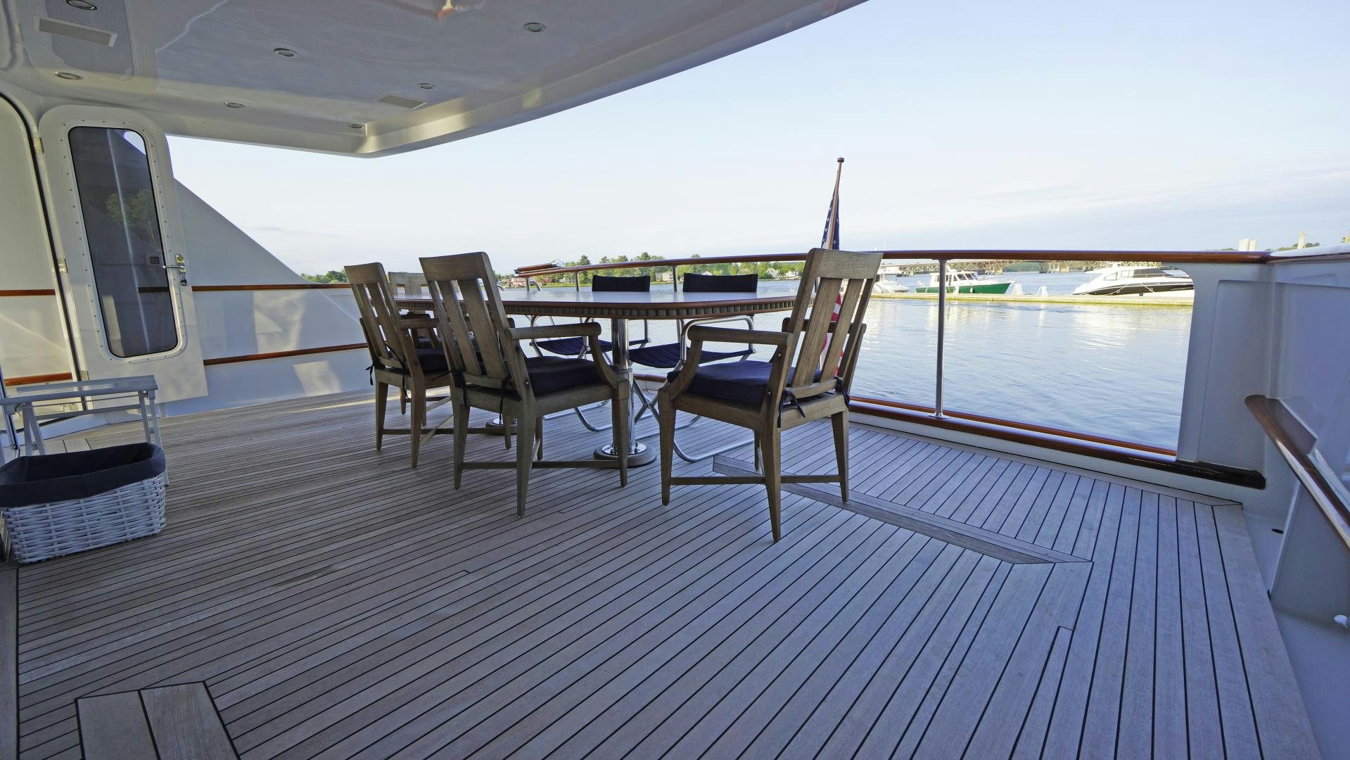 a deck with chairs and a table on it aboard LAID BACK Yacht for Sale