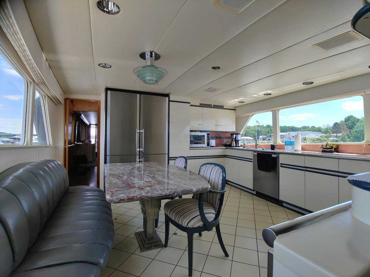 a kitchen with a table and chairs aboard LAID BACK Yacht for Sale