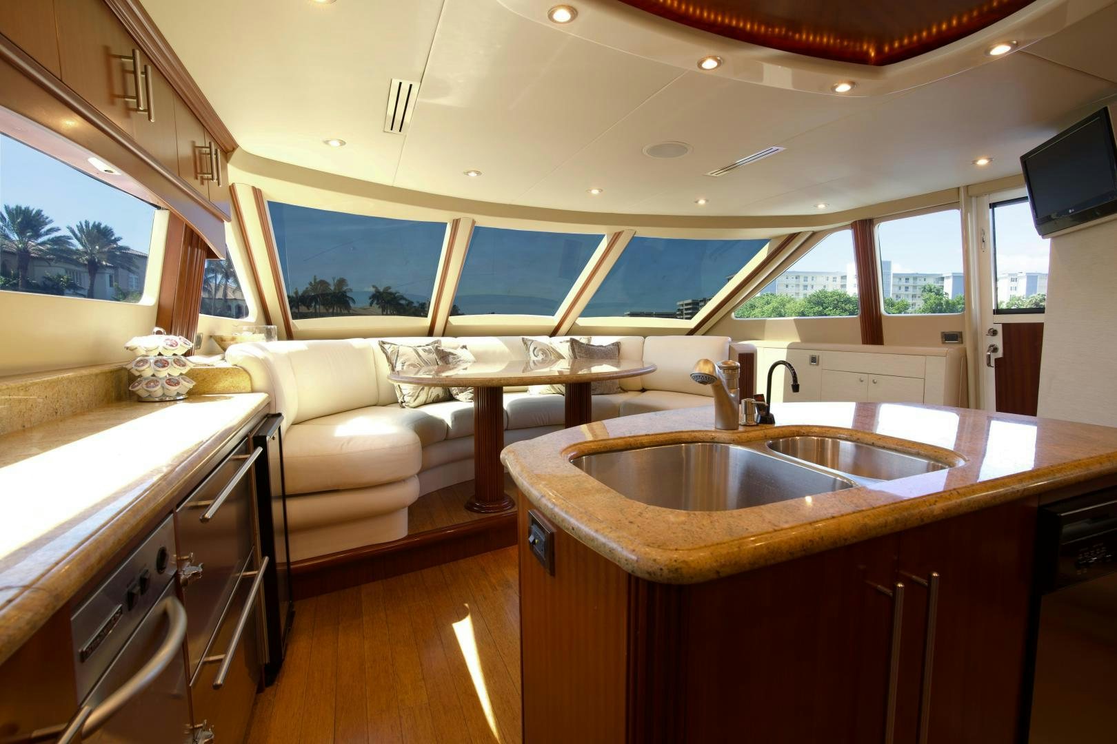 a kitchen with a sink and a couch aboard new horizon Yacht for Sale