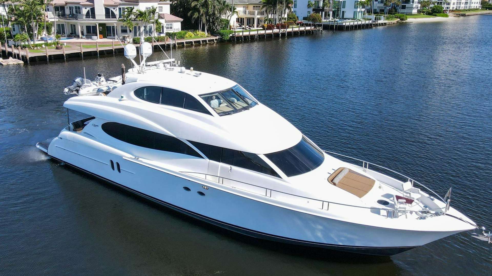 a white yacht in a harbor aboard new horizon Yacht for Sale