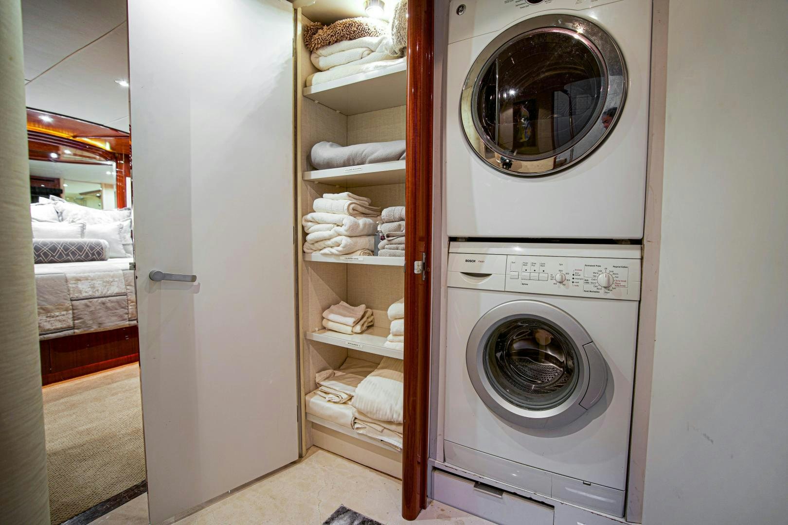a white laundry room aboard new horizon Yacht for Sale