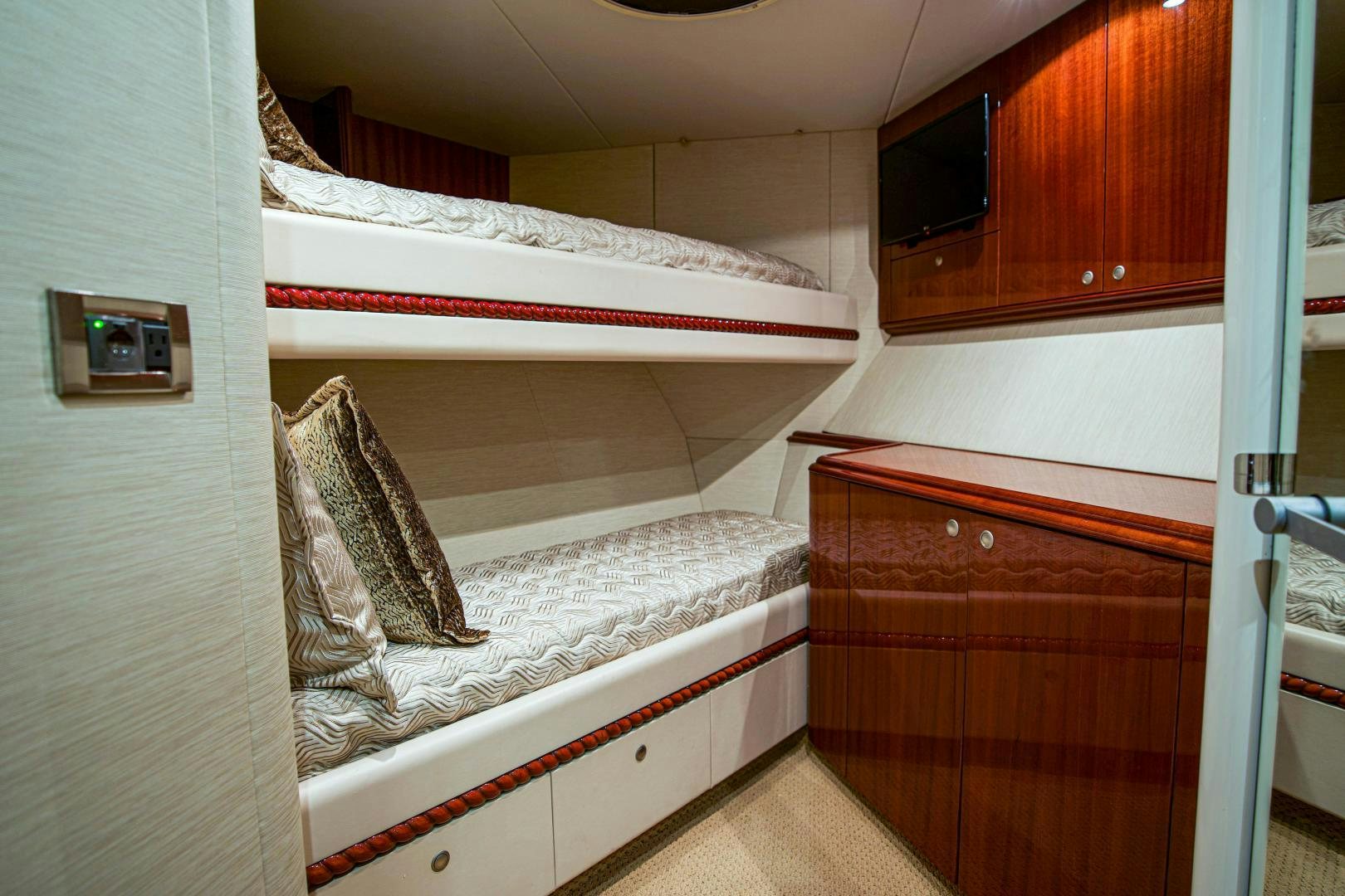 a bedroom with a bed and a dresser aboard new horizon Yacht for Sale
