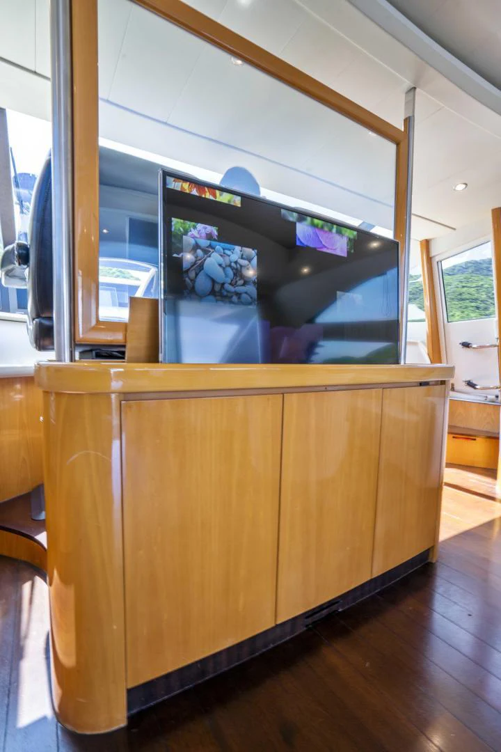 a wood cabinet with a screen aboard DENISE Yacht for Sale