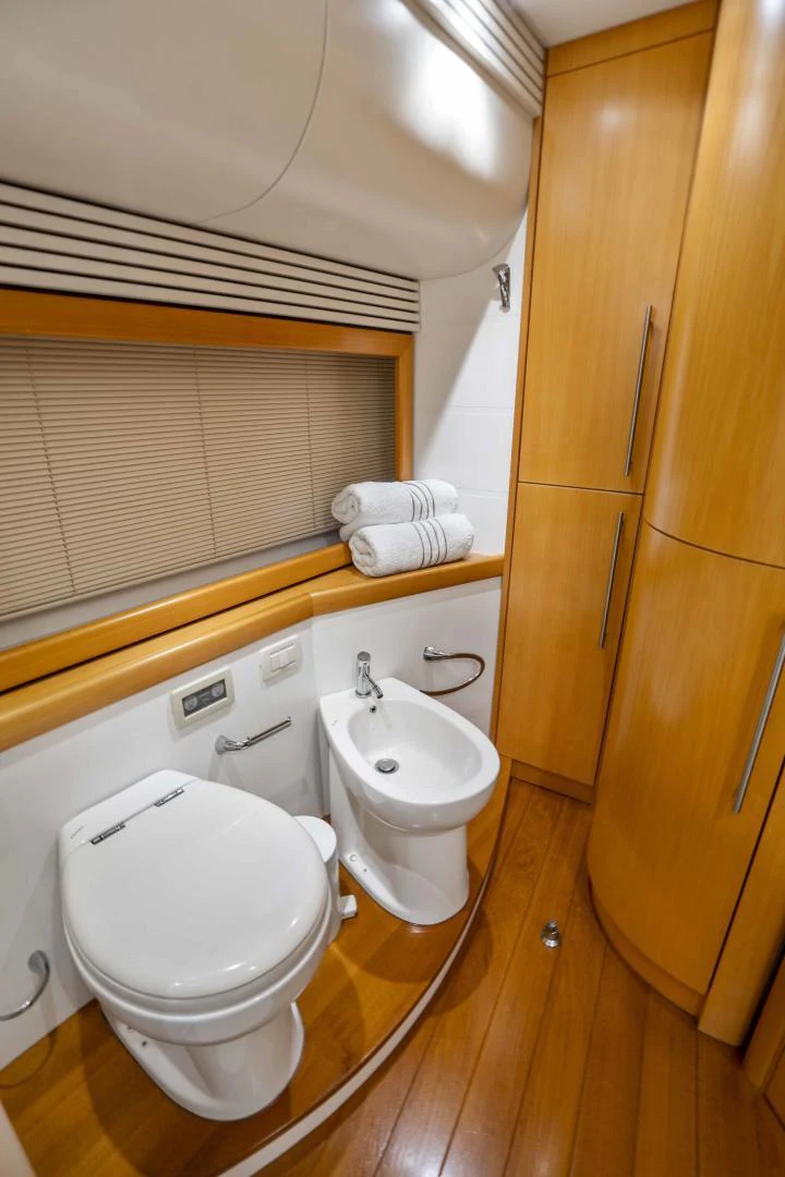 a bathroom with a toilet sink and a mirror aboard DENISE Yacht for Sale