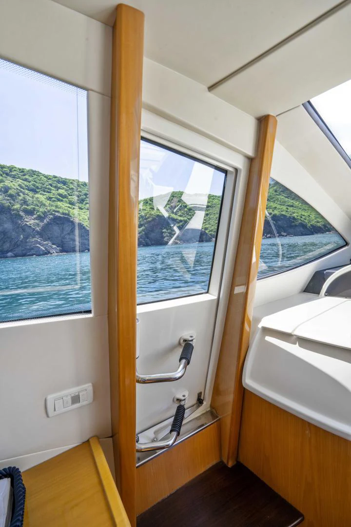 a window with a view of a forest aboard DENISE Yacht for Sale
