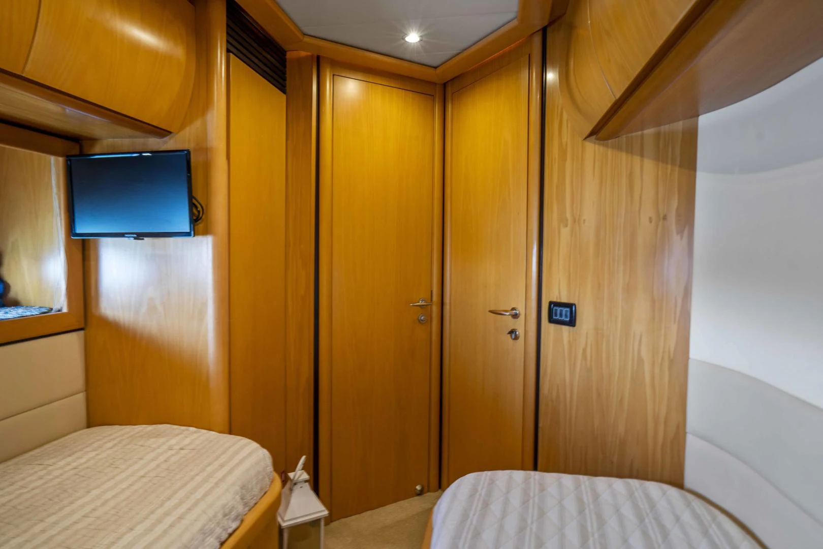 a room with a bed and a television aboard DENISE Yacht for Sale