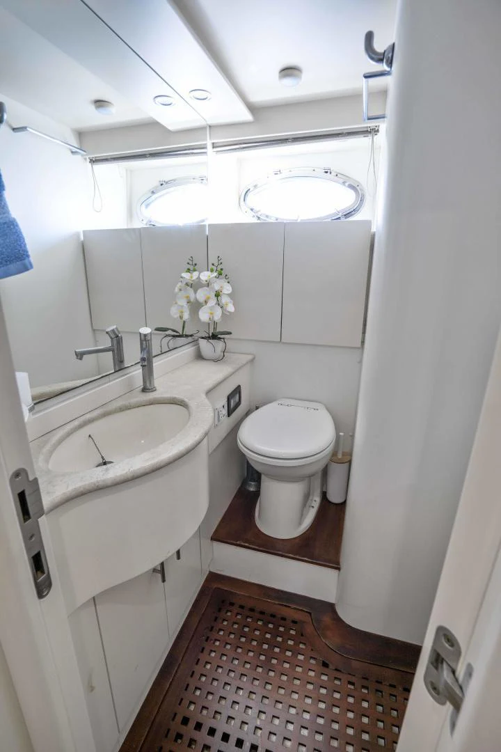 a bathroom with a red and white rug aboard DENISE Yacht for Sale