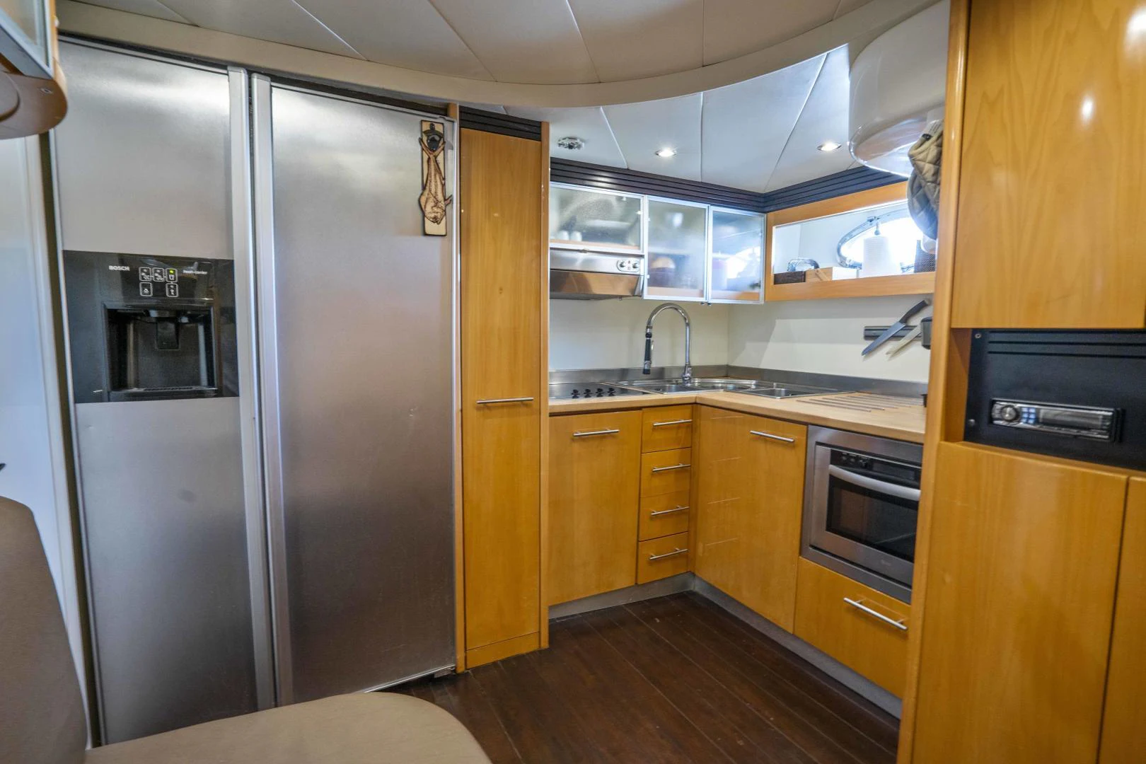 a kitchen with wooden cabinets aboard DENISE Yacht for Sale