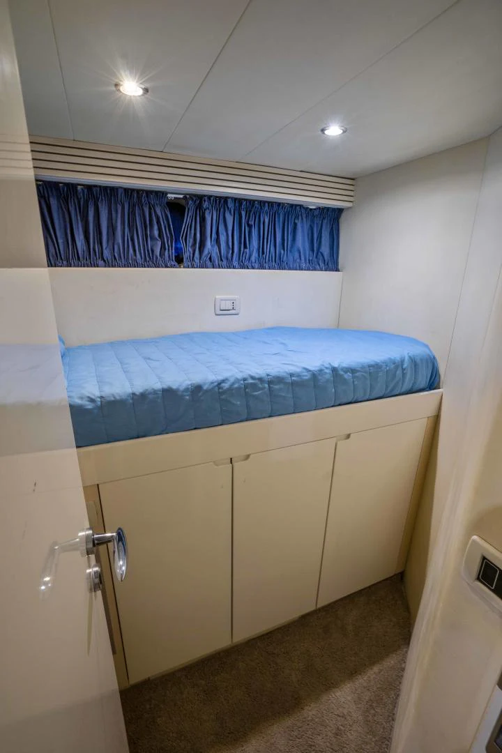a blue and white bed in a room aboard DENISE Yacht for Sale