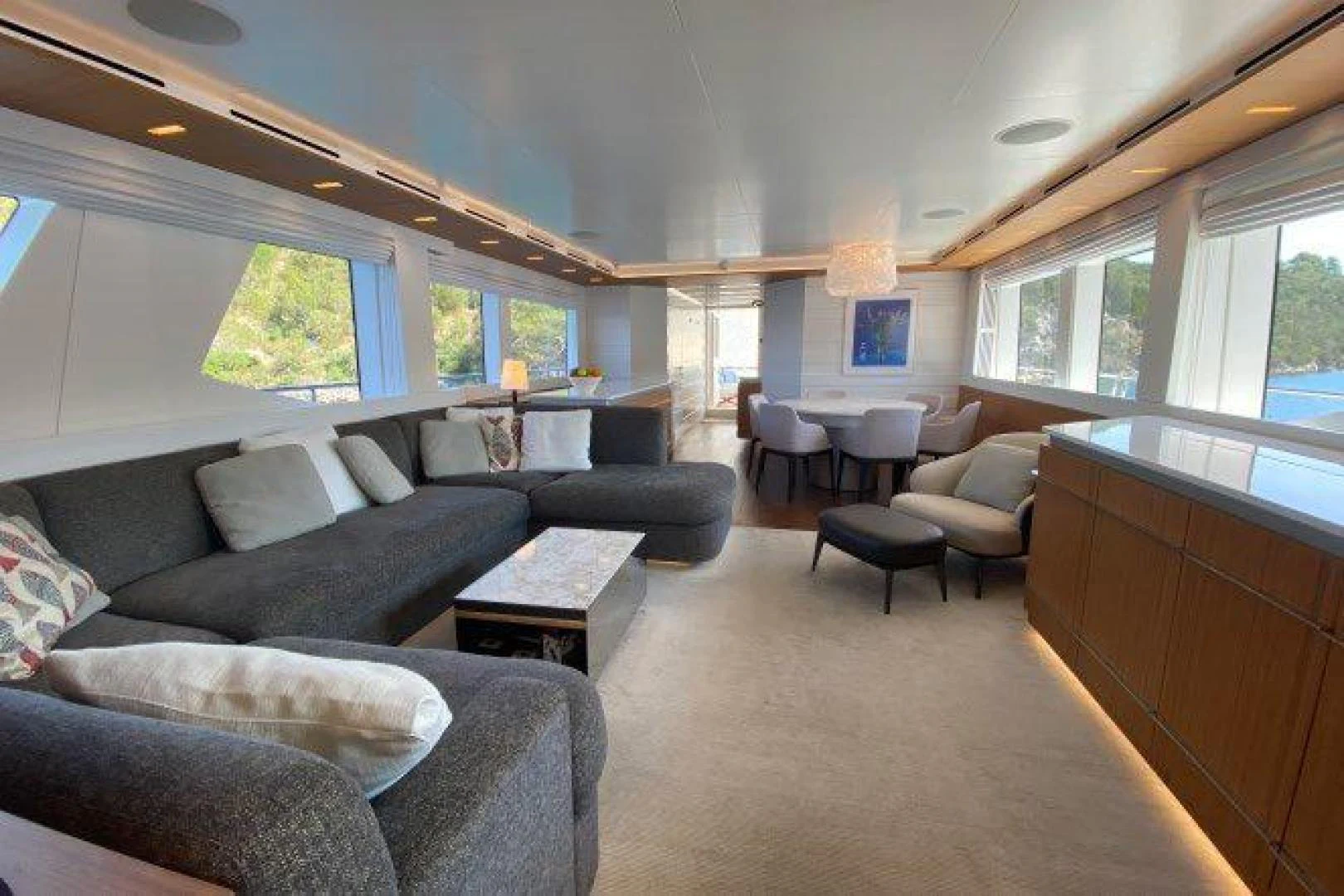 a living room with a couch and a coffee table aboard YES Yacht for Sale