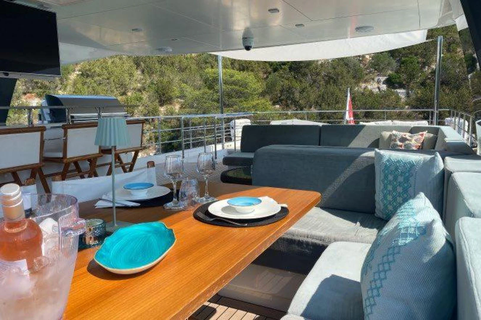 a table with plates and glasses on it aboard YES Yacht for Sale
