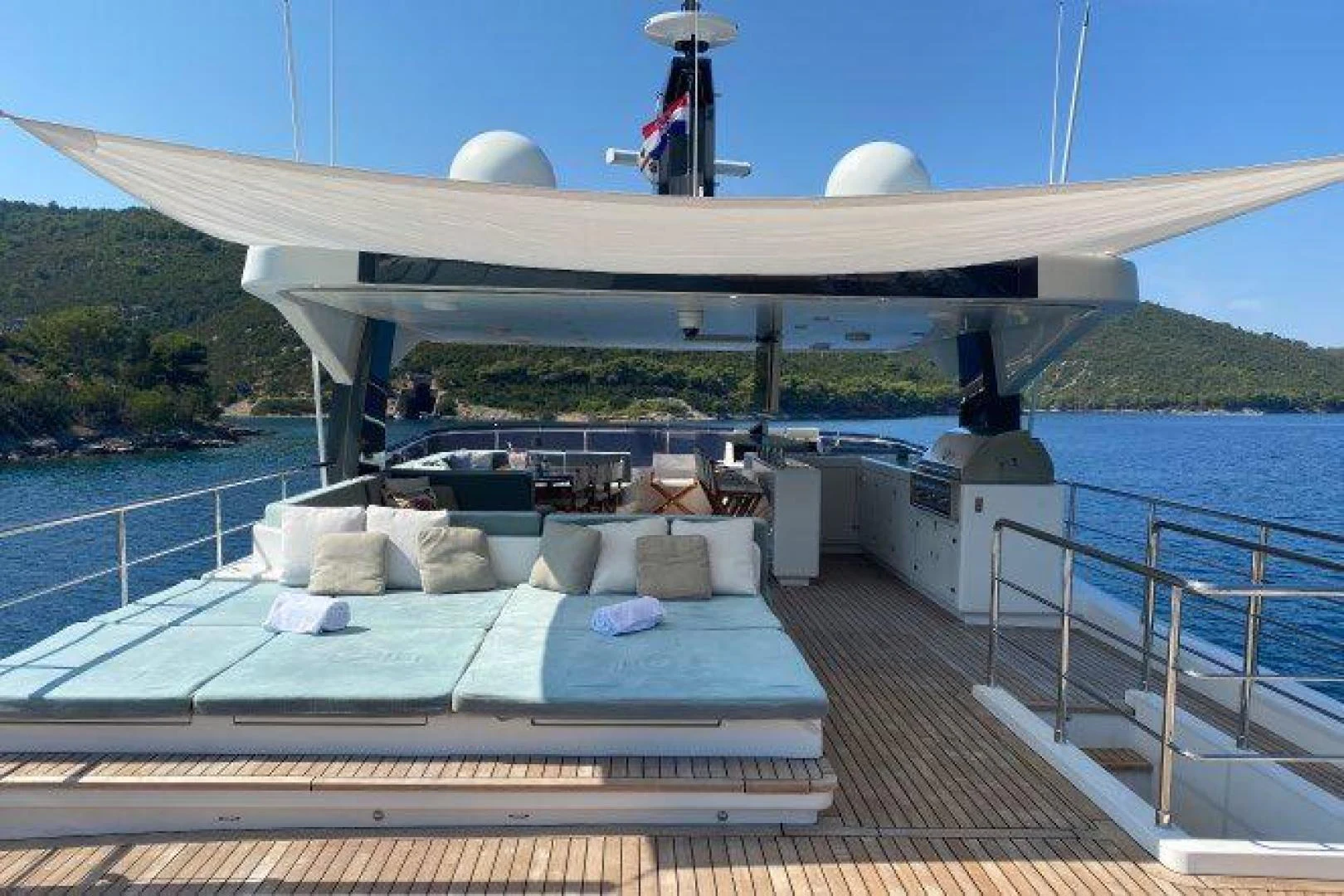 a deck with a pool and a large white building with a dome and a large white dome on aboard YES Yacht for Sale