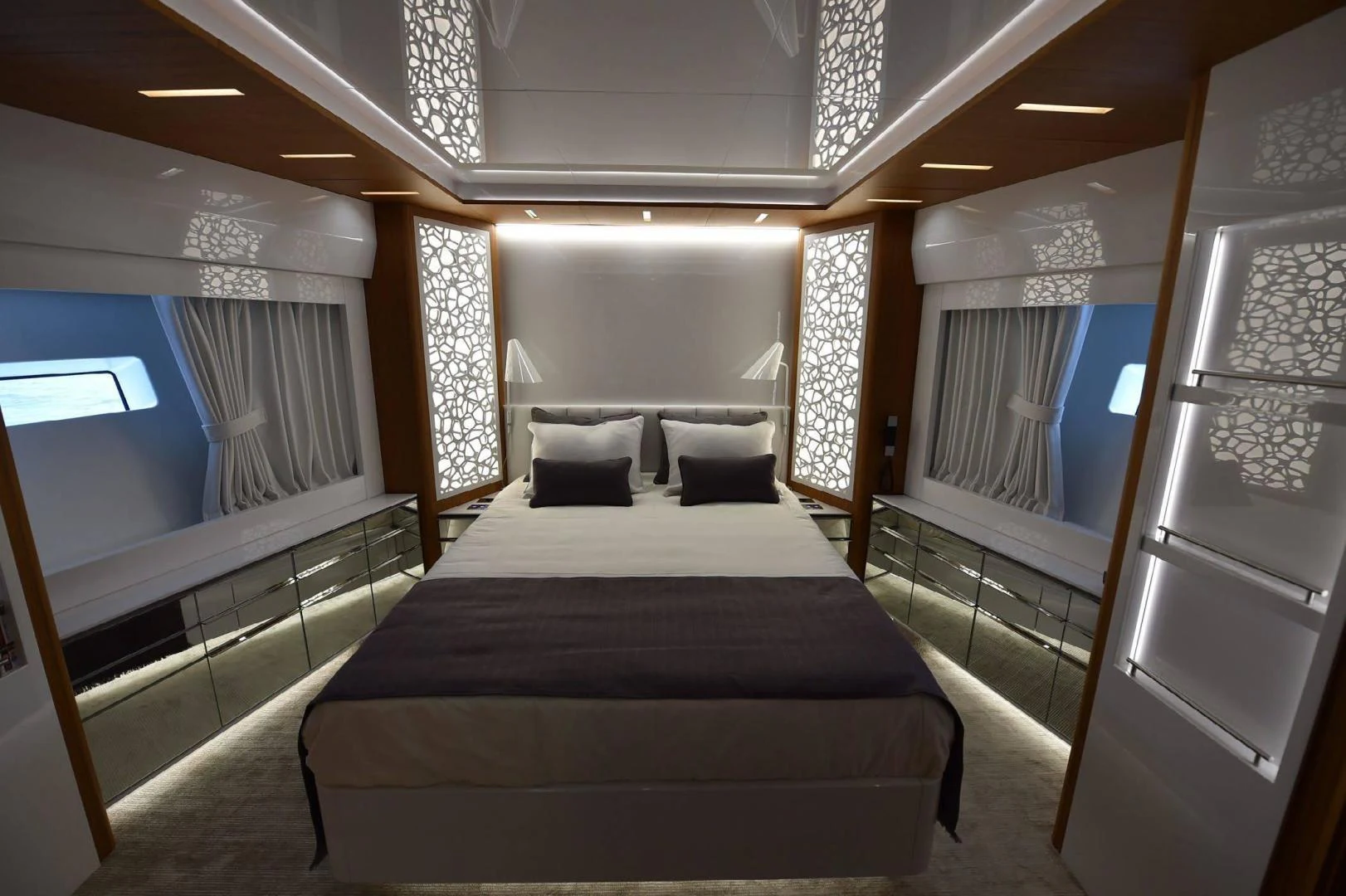 a room with a bed and a window aboard YES Yacht for Sale