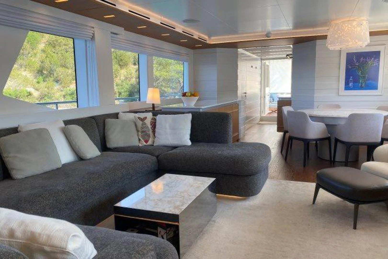 a living room with a couch and a coffee table aboard YES Yacht for Sale
