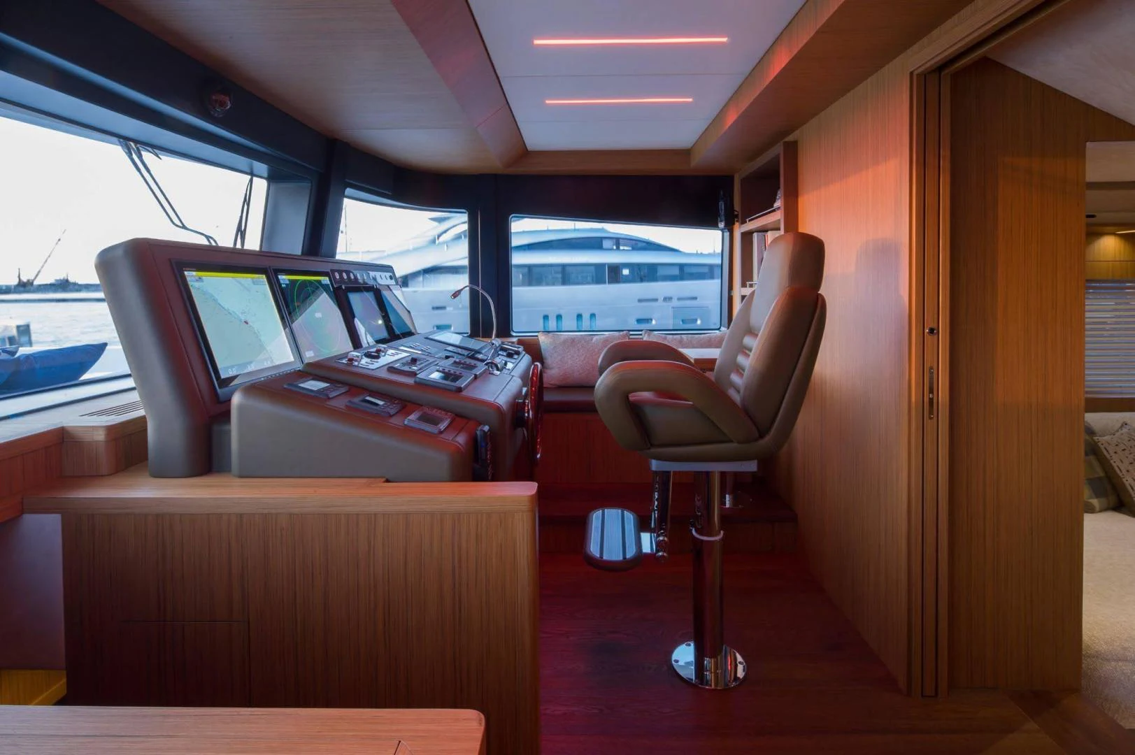 a red chair next to a desk aboard YES Yacht for Sale