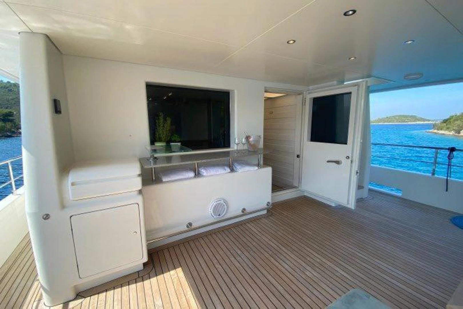 a large white room with a large window and a pool aboard YES Yacht for Sale