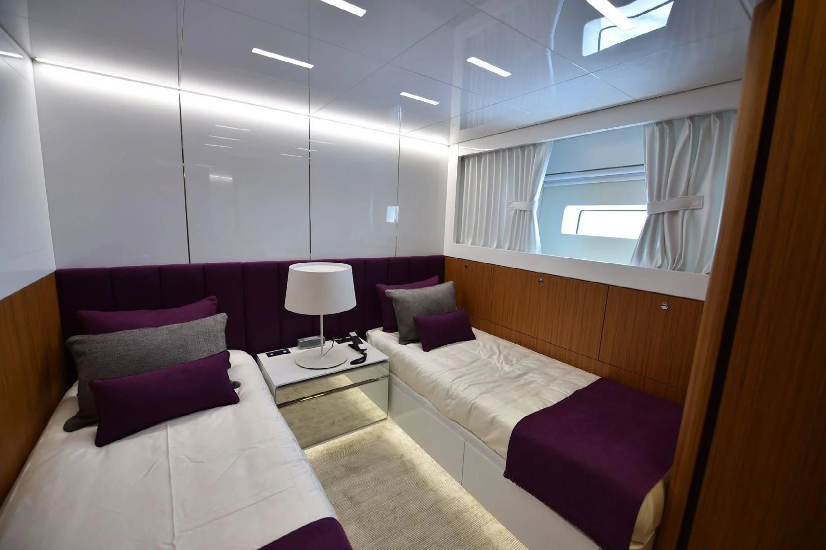 a room with a bed and a window aboard YES Yacht for Sale