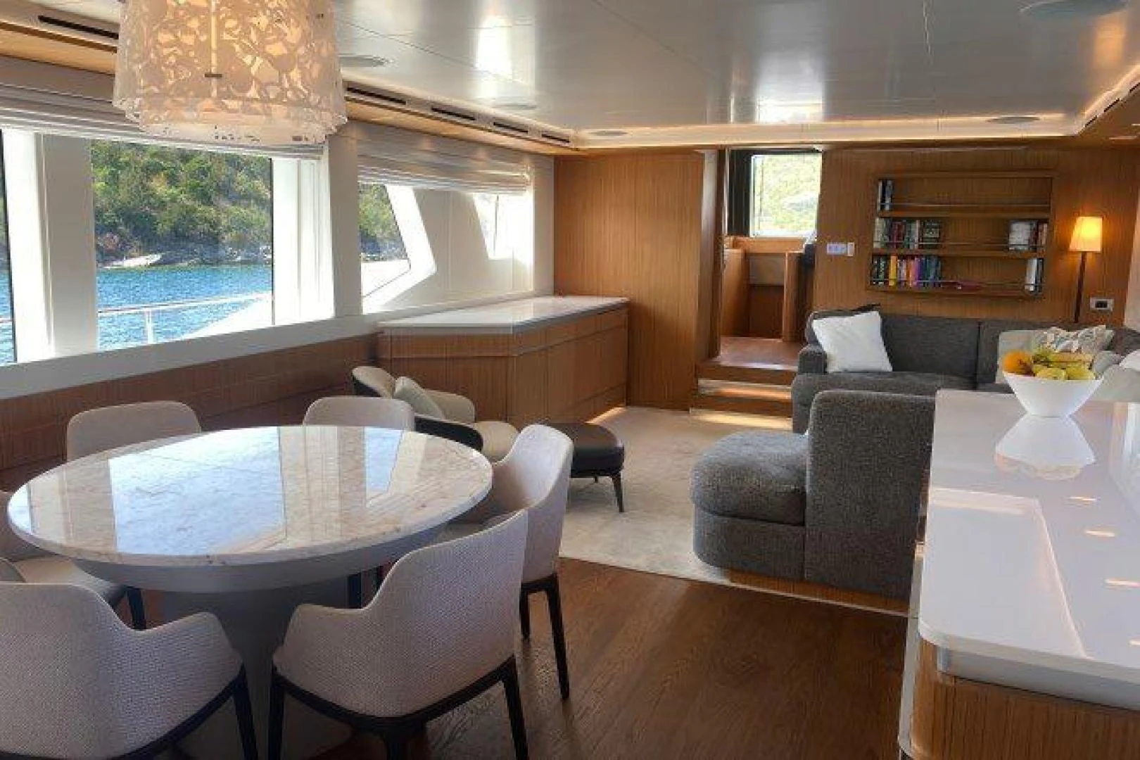 a living room with a table and chairs aboard YES Yacht for Sale