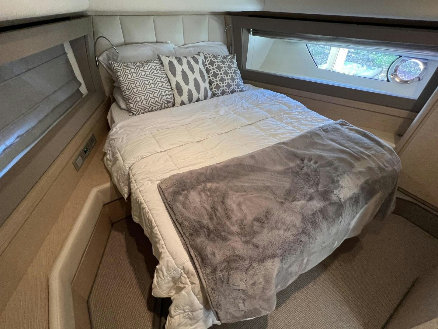 a bed with a television on the wall aboard FERRETTI  Yacht for Sale