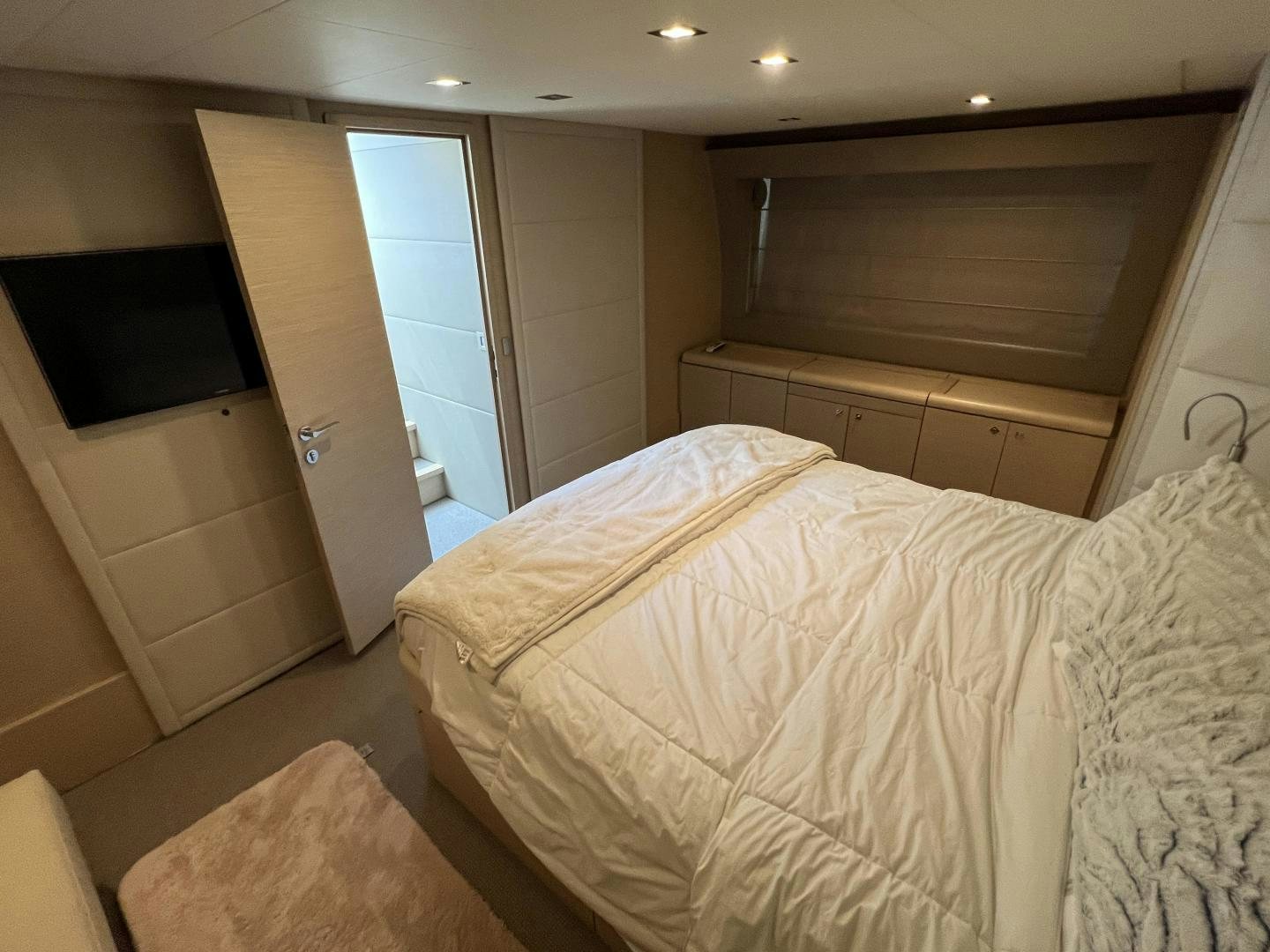 a room with a bed and a television aboard FERRETTI  Yacht for Sale